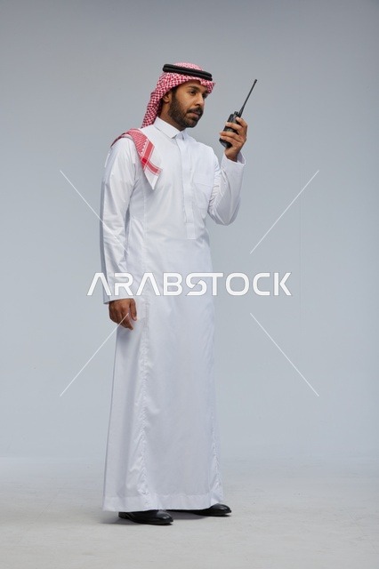 Saudi man using walkie-talkie for communication