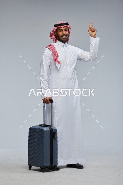Saudi Man with Suitcase Pointing Up in Studio