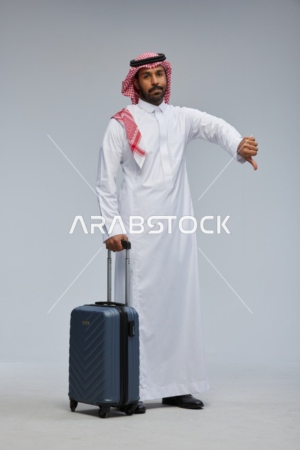 Saudi Man with Suitcase Making Thumbs Down Gesture