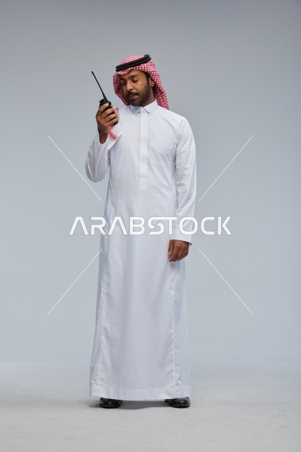 Saudi man using walkie-talkie for communication