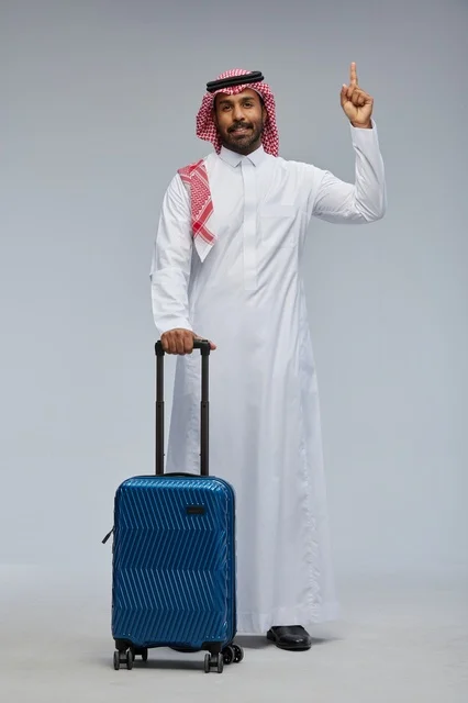 Saudi Man in Traditional Thobe with Blue Suitcase