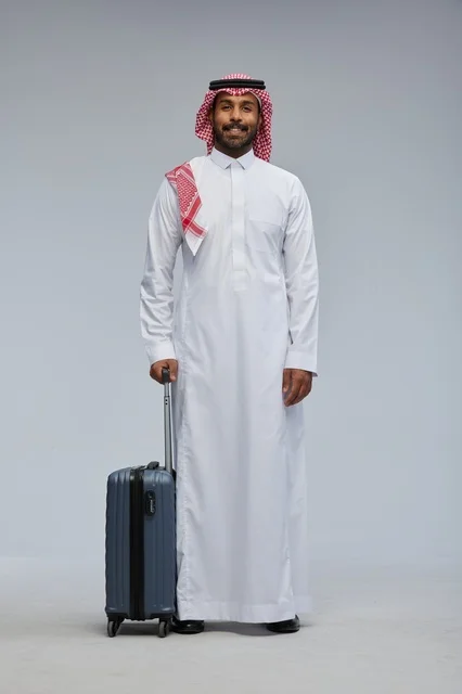 Saudi Man with Travel Suitcase in Traditional Attire