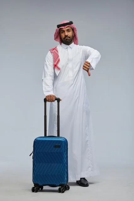 Saudi Man with Suitcase Disappointed Thumbs Down Studio