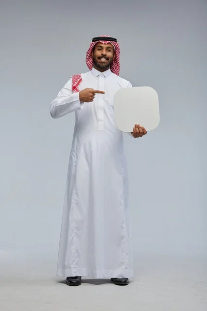 Smiling Saudi Man in Traditional Thobe Holding Blank Board