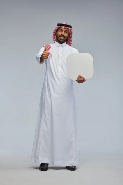 Smiling Saudi man holding blank sign board Smiling Saudi man holding blank sign board