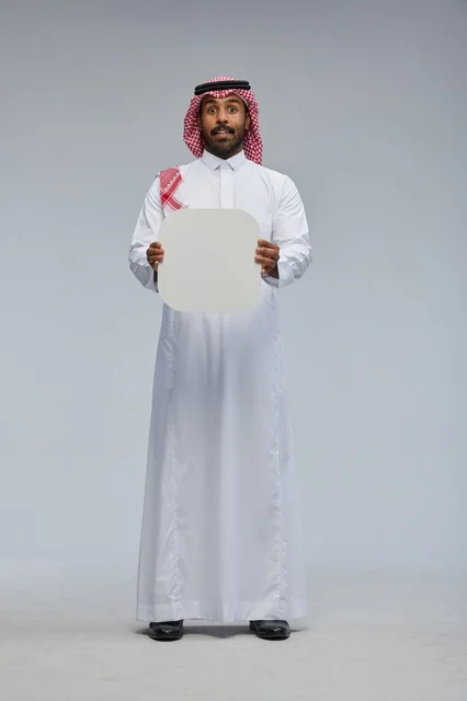 Smiling Saudi man holding blank sign board Smiling Saudi man holding blank sign board
