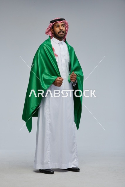 Saudi Man in Traditional Thobe Wearing National Flag