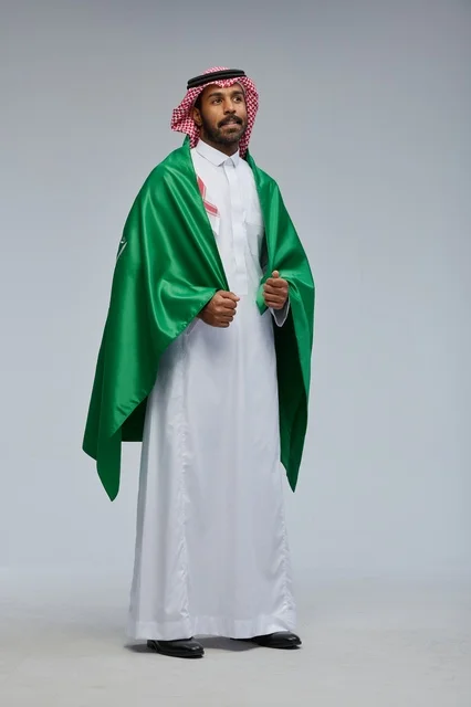Saudi Man in Traditional Thobe Wearing National Flag