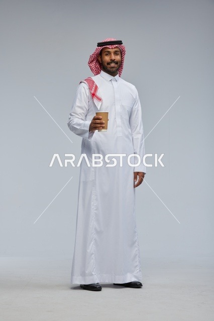 Saudi Man Holding Coffee Cup in Traditional Thobe