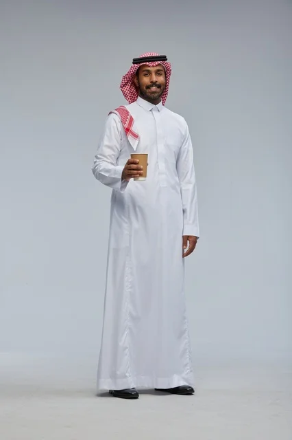 Saudi Man Holding Coffee Cup in Traditional Thobe