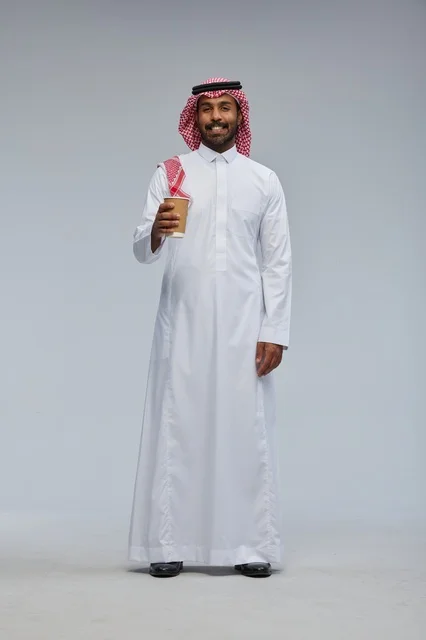Saudi Man in Traditional Thobe Holding Coffee Cup