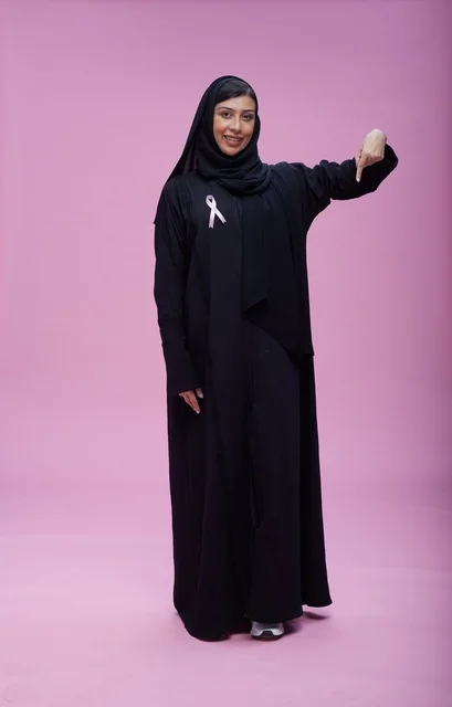 Saudi Woman with Breast Cancer Awareness Ribbon Pink Background