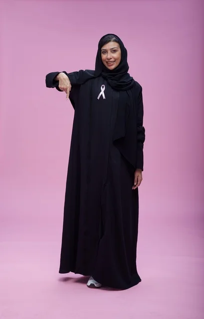 Saudi Woman with Breast Cancer Awareness Ribbon on Pink