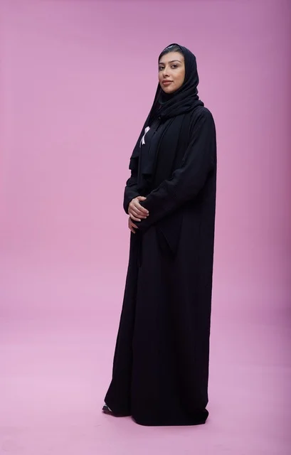Saudi Woman Wearing Breast Cancer Ribbon on Pink Background