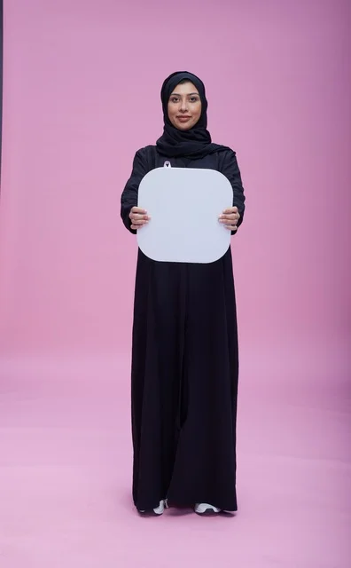 Saudi Woman Holding Blank White Board on Pink Background