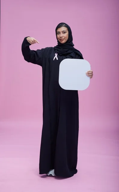 Saudi Woman with Breast Cancer Ribbon and Blank Sign