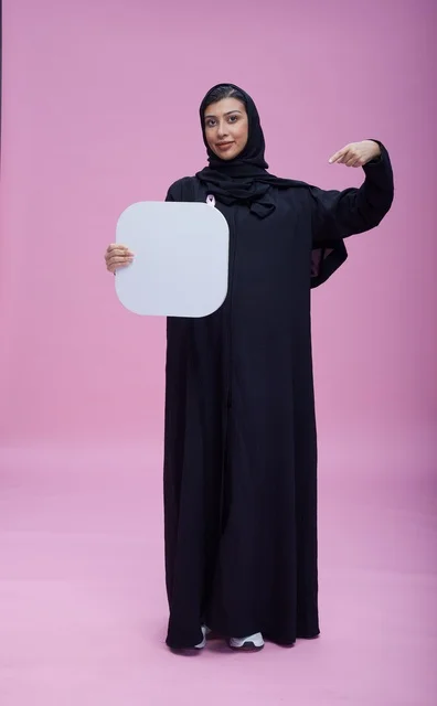 Saudi Woman Holding Blank Sign Board on Pink Background