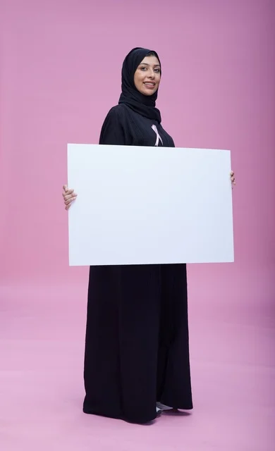 Saudi Woman Holding Blank Board for Breast Cancer Awareness