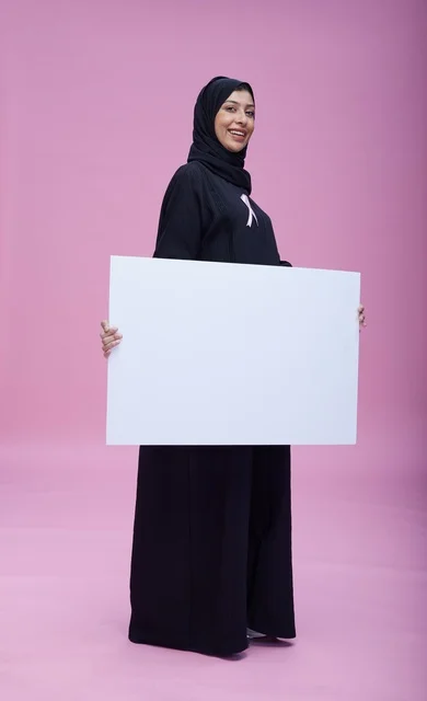 Saudi Woman Holding Blank Sign for Breast Cancer Awareness