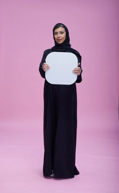 Saudi Woman Holding Blank White Board on Pink Background