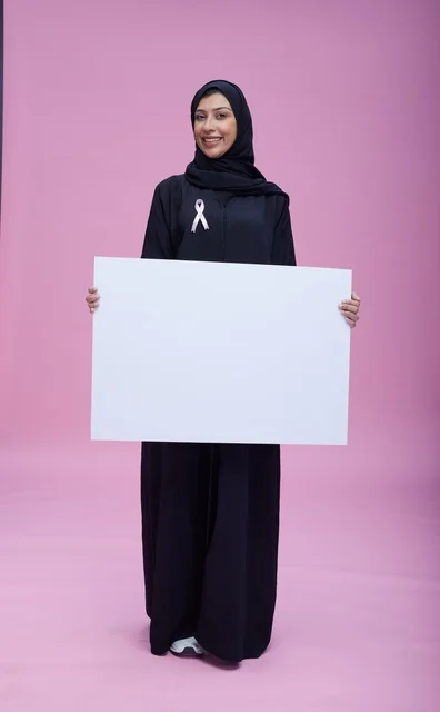 Saudi Woman Holding Blank White Awareness Sign Pink Background