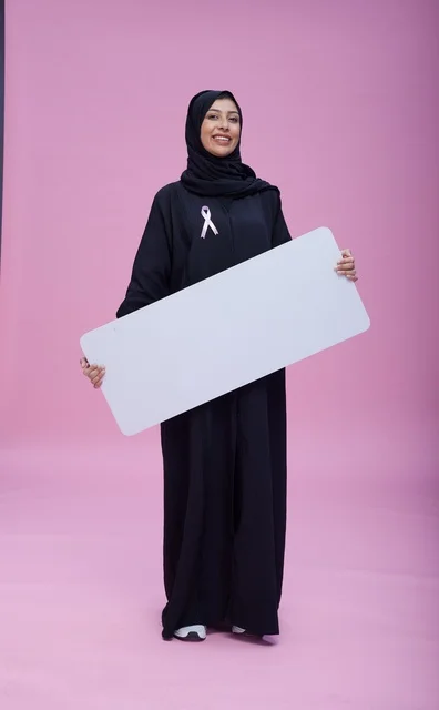 Saudi Woman with Blank Sign for Breast Cancer Awareness