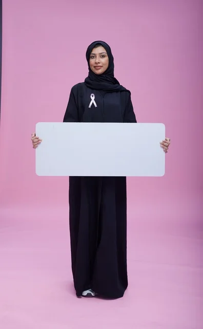 Saudi Woman with Breast Cancer Awareness Sign