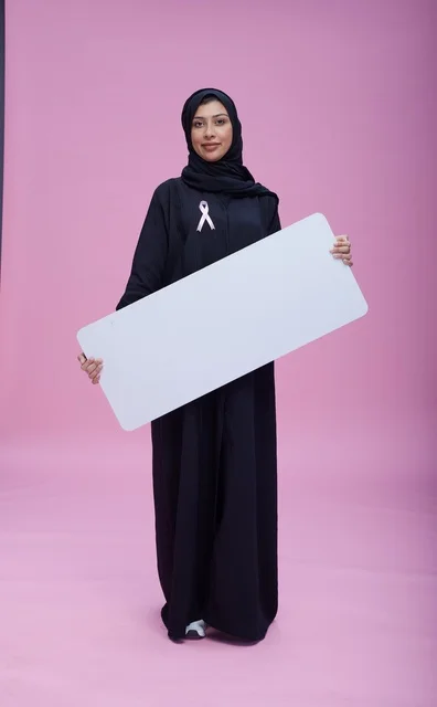Saudi Woman Holding Blank Board for Breast Cancer Awareness