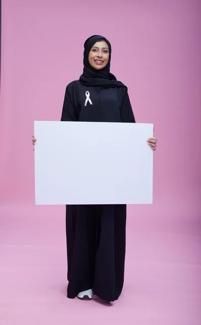 Saudi Woman Holding Blank Breast Cancer Awareness Sign