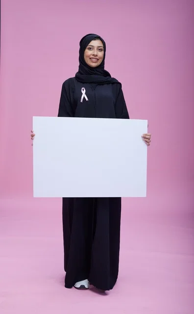 Saudi Woman with Blank Sign for Breast Cancer Awareness