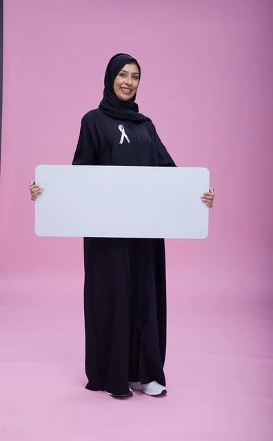Saudi Woman Holding Blank Breast Cancer Awareness Sign