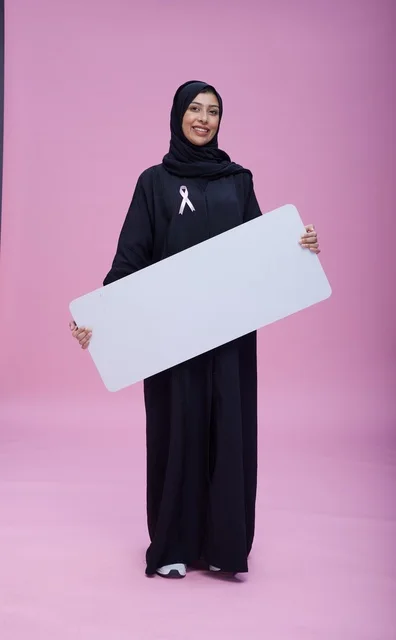 Saudi Woman with Pink Ribbon Holding Blank Sign Board