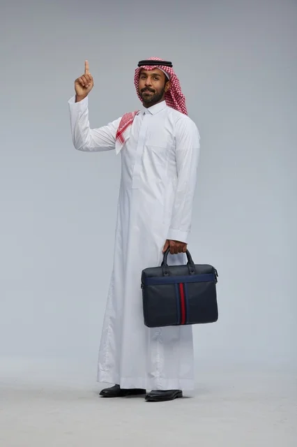 Saudi Businessman with Briefcase Pointing Upwards Studio