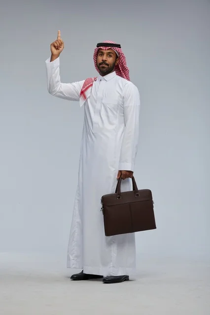 Saudi Businessman with Briefcase Pointing Up in Studio