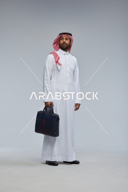 Saudi Businessman in Thobe Walking with Briefcase