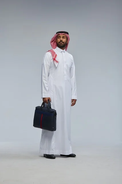 Saudi Businessman in Thobe Walking with Briefcase