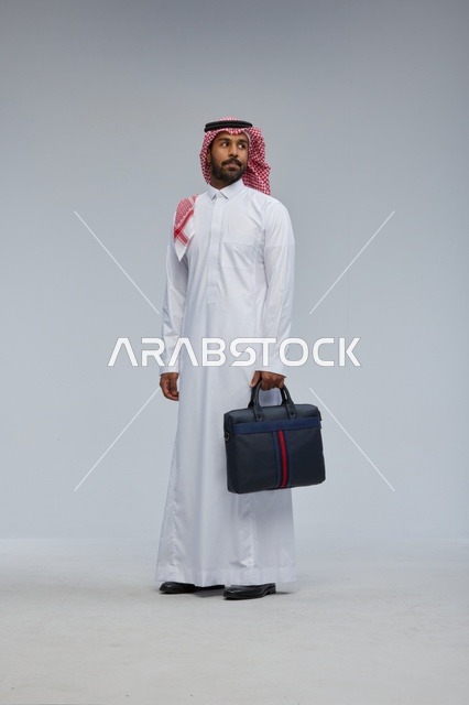 Saudi Businessman with Briefcase in Studio Portrait