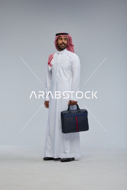 Saudi Businessman with Briefcase in Studio Background