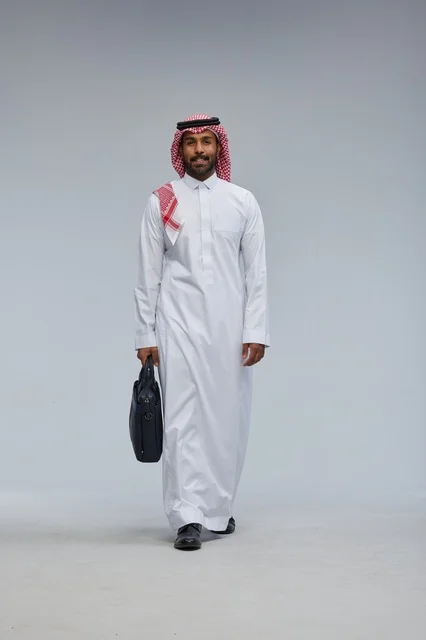 Saudi Businessman Walking with Briefcase on Grey Background