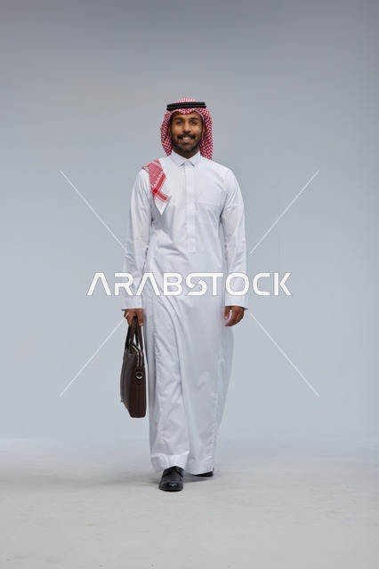 Saudi Businessman Walking with Briefcase on Grey Background