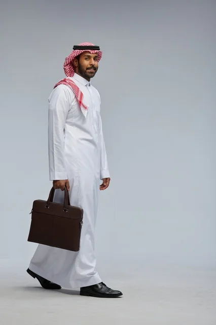 Saudi Businessman Walking in Studio with Briefcase