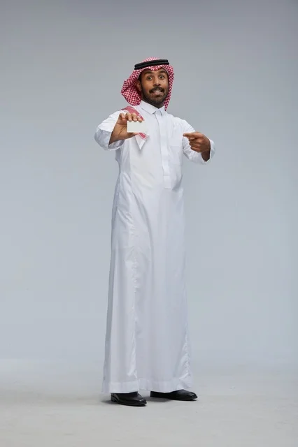 Saudi Man Holding Blank Business Card in Studio
