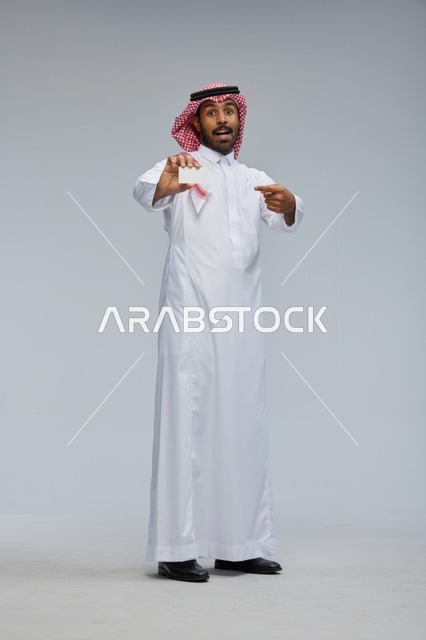 Saudi Man Holding Blank Card in Studio Full Length