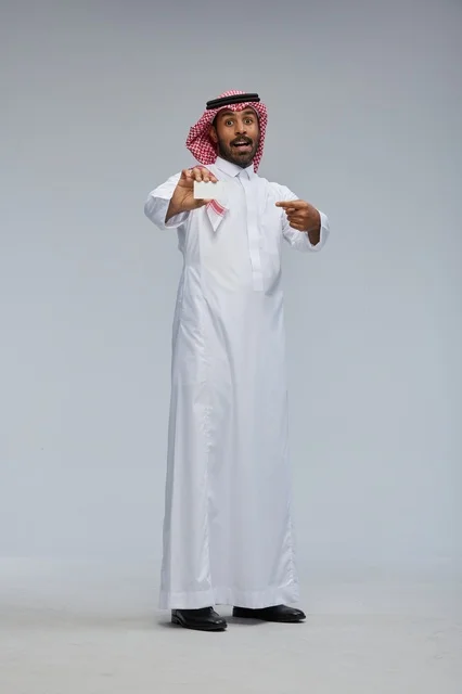 Saudi Man Holding Blank Card in Studio Full Length