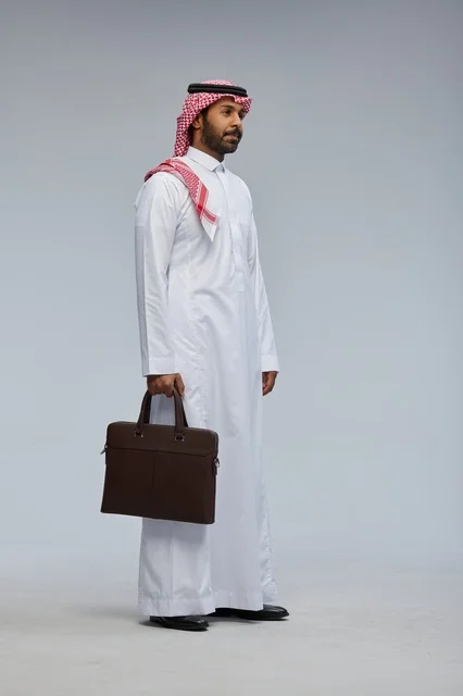 Saudi Businessman Walking with Briefcase in Studio