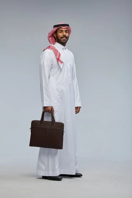 Saudi Businessman with Briefcase on Grey Background