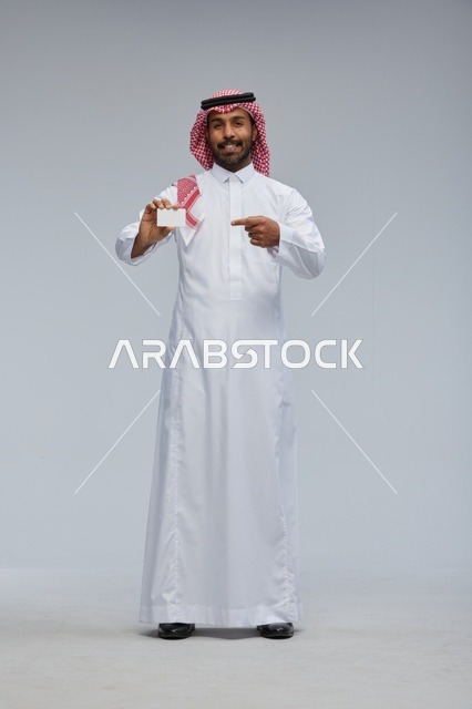 Saudi Man Holding Blank White Card in Studio Full Body