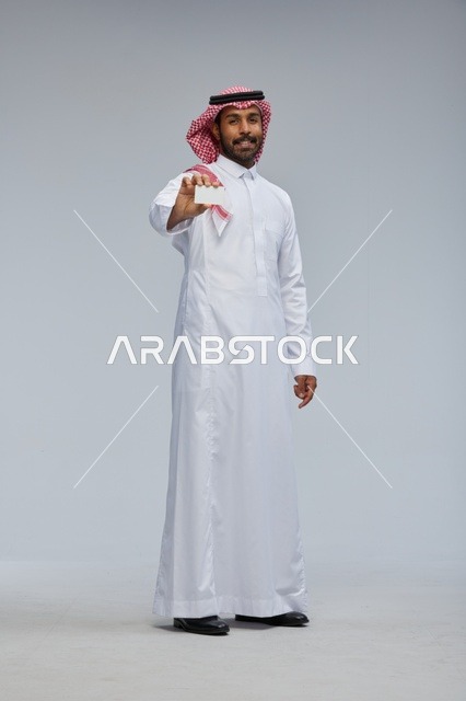 Saudi Man Holding Blank White Card in Traditional Dress