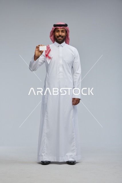 Saudi Man Holding Blank Card in Studio Full Body