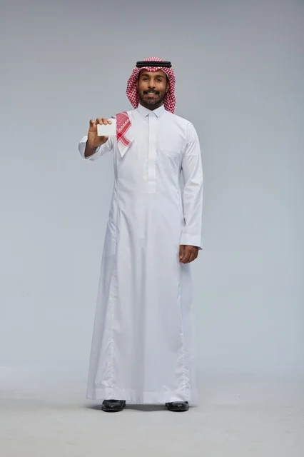 Saudi Man Holding Blank Business Card on Grey Background